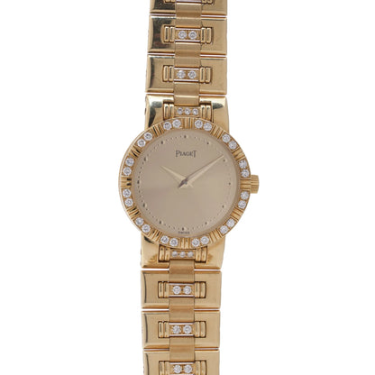 A ladies Piaget yellow gold and diamond wristwatch with champagne coloured dial, on a white background
