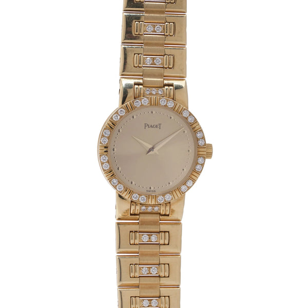 A ladies Piaget yellow gold and diamond wristwatch with champagne coloured dial, on a white background