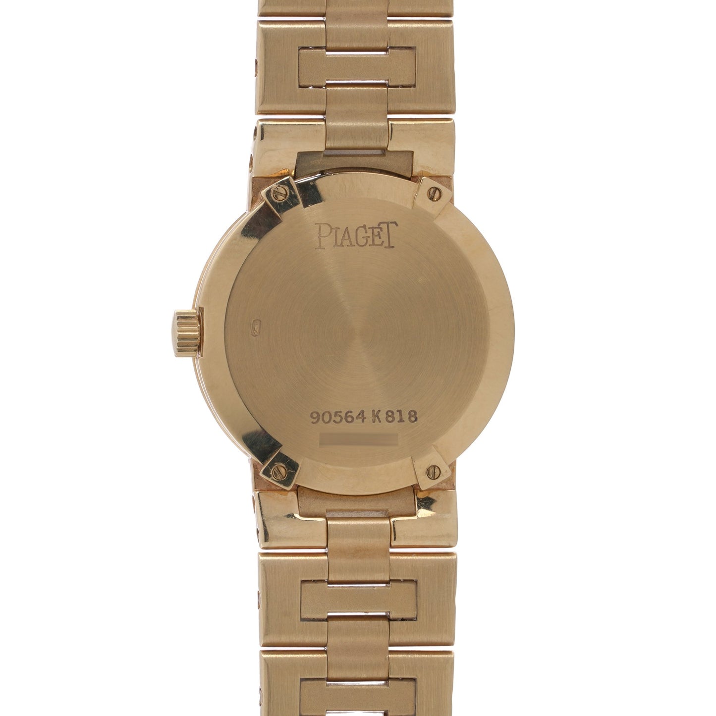The back of a yellow gold Piaget wristwatch in yellow gold, on a white background