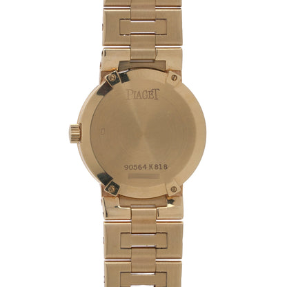 The back of a yellow gold Piaget wristwatch in yellow gold, on a white background