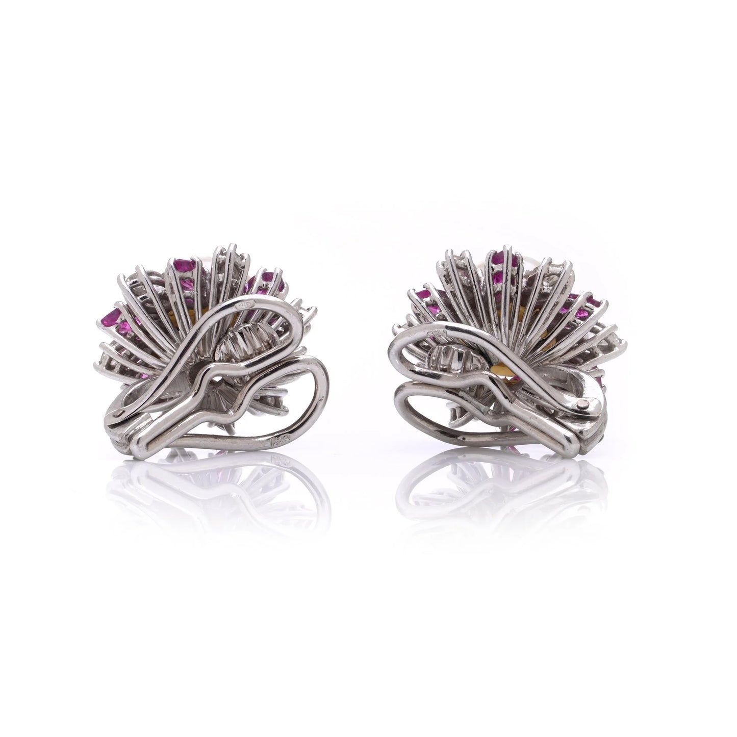 A pair of pearl, pink sapphire and diamond cluster earrings in white gold, on a white background