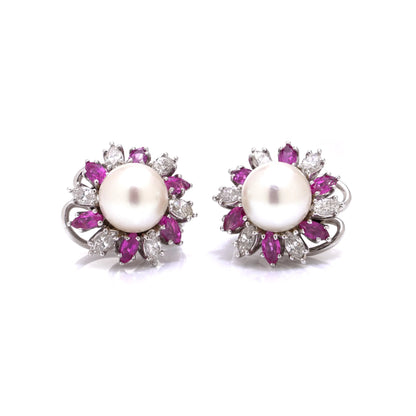 A pair of pearl, pink sapphire and diamond cluster earrings in white gold, on a white background