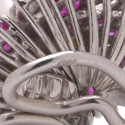 Close-up of a stamp on the back of a white gold earring fitting