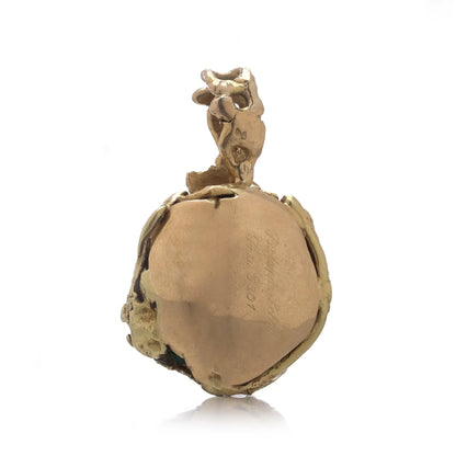 A yellow gold free-form pendant, on a white background