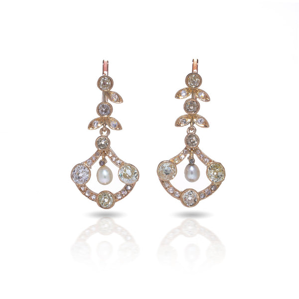 A pair of pearl and old cut diamond drop earrings with leaf motifs in yellow gold, on a white background