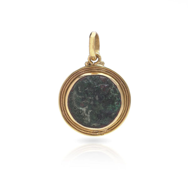 A yellow gold pendant featuring an oxidised ancient Roman coin, on a white background