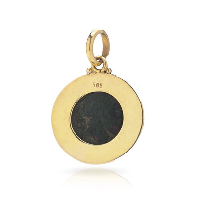 A yellow gold pendant featuring an oxidised ancient Roman coin, stamped 585, on a white background