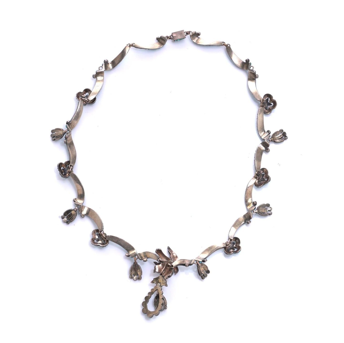 An antique silver fancy necklace with drop pendants, on a white background