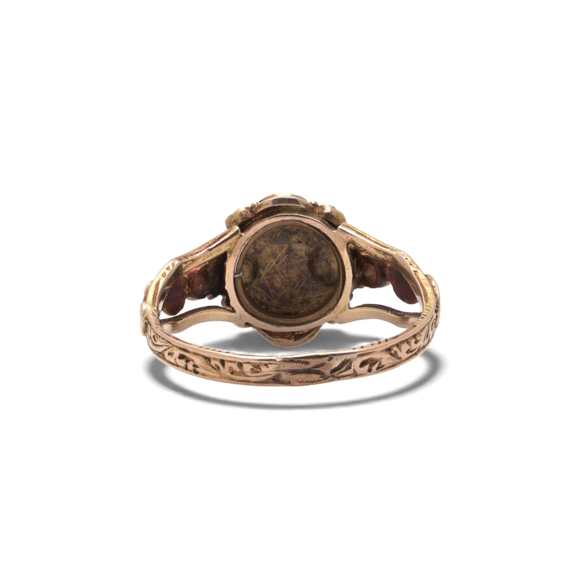 An antique gold ring with decorative shank, on a white background