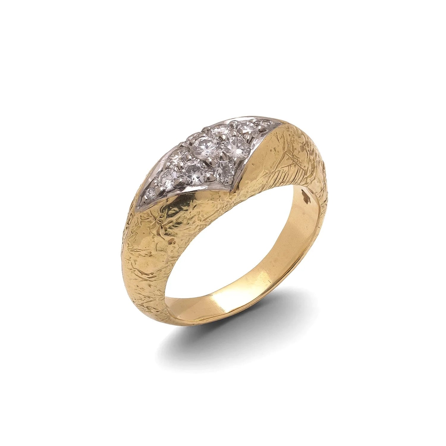 A yellow and white gold diamond ring with a textured shank, on a white background