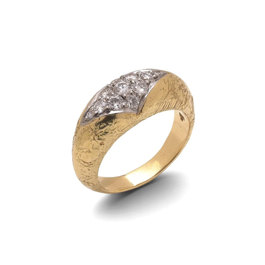 A yellow and white gold diamond ring with a textured shank, on a white background