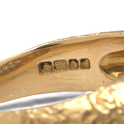 An 18ct gold hallmark inside a gold ring shank