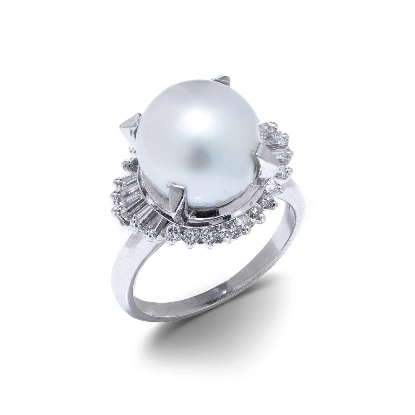 A platinum ring featuring a large white pearl surrounded by baguette and brilliant cut diamonds, on a white background