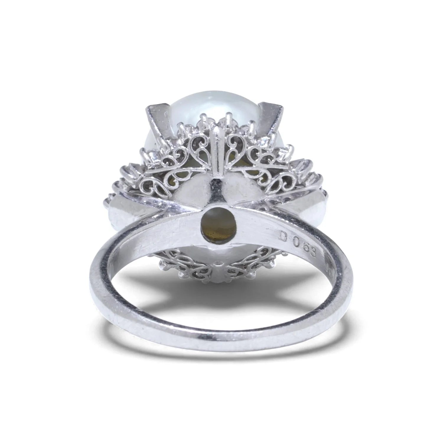A platinum ring featuring a large white pearl surrounded by baguette and brilliant cut diamonds, on a white background