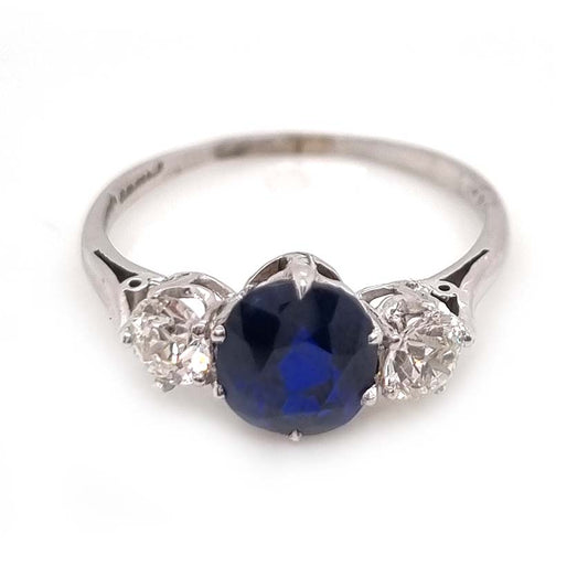 Art Deco 1.69ct Sapphire and Diamond Trilogy Three Stone Engagement Ring in Platinum, 1.69ct oval cushion-shaped Royal blue sapphire flanked by 0.60cts old mine-cut diamonds