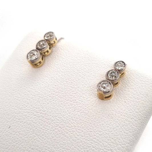 Edwardian Antique Diamond Drop Earrings, three slightly graduated old European transitional cut diamonds in platinum to 18ct yellow gold. Circa 1900