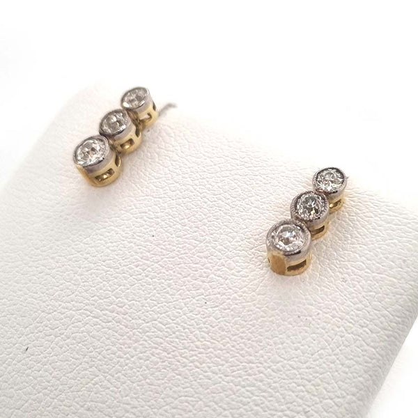 Edwardian Antique Diamond Drop Earrings, three slightly graduated old European transitional cut diamonds in platinum to 18ct yellow gold. Circa 1900