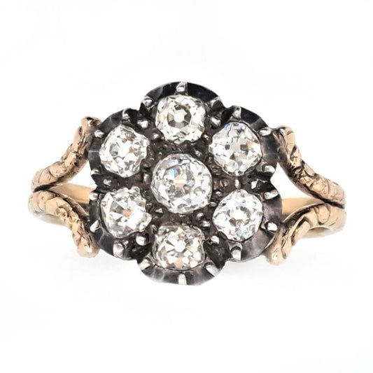 Antique Old Cut Diamond Flower Cluster Engagement Ring, 0.80 carat total, old mine-cut diamond surrounded by six diamonds in timeless floral design in yellow gold with decorative split shoulders