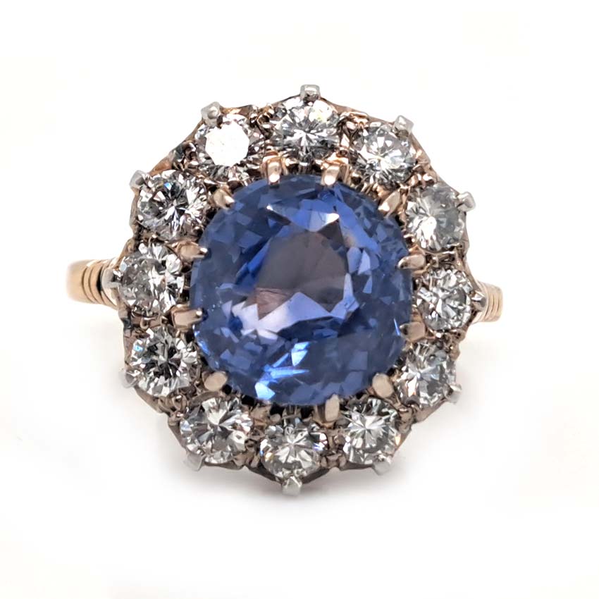 Antique Art Deco 4.50ct Cornflower Blue Ceylon Sapphire and 1.20ct Diamond Cluster Engagement Ring in 18ct white and yellow gold. Circa 1920
