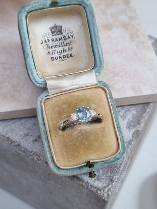 Aquamarine Three stone trilogy engagement ring with a 0.61ct oval cut aquamarine and 0.20ct of round cut diamonds, set in 18ct white gold