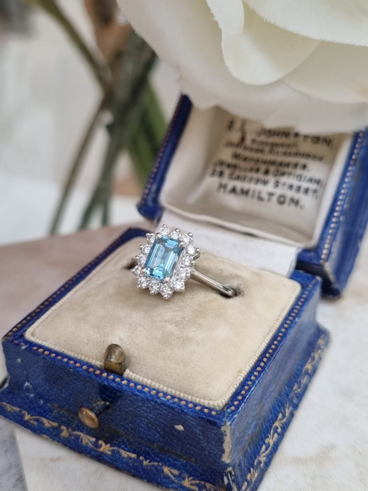 Aquamarine and diamond cluster engagement ring set in 18ct white gold