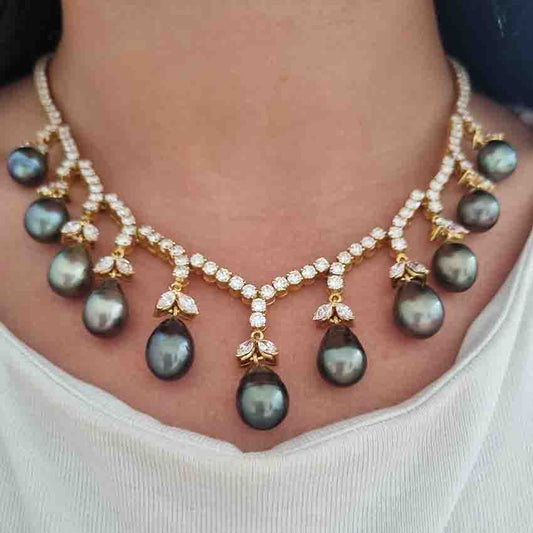 Vintage Tahitian Pearl and Diamond Necklace, diamond line necklace leads to gently graduating grey Tahitian pearl pendant drops with delicate diamond leaf tops in high carat 22ct 24ct yellow gold