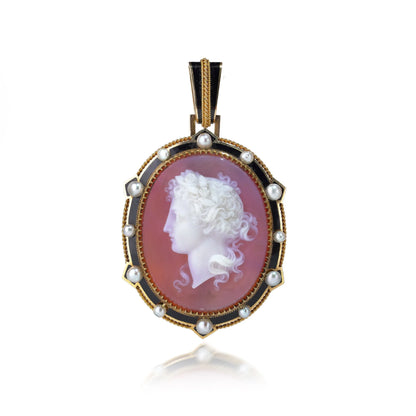 A cameo pendant in yellow gold with pearls and black enamel details