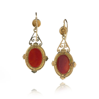 A pair of cameo earrings in yellow gold with pearls and black enamel details