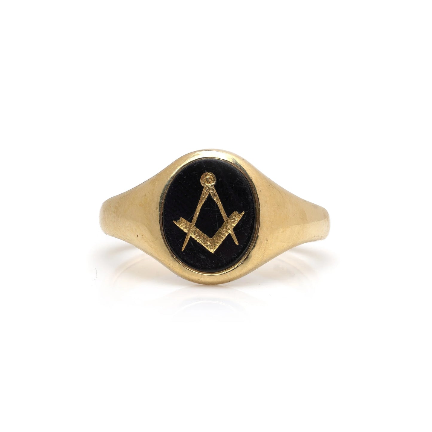 A yellow gold signet ring with an oval onyx masonic plaque