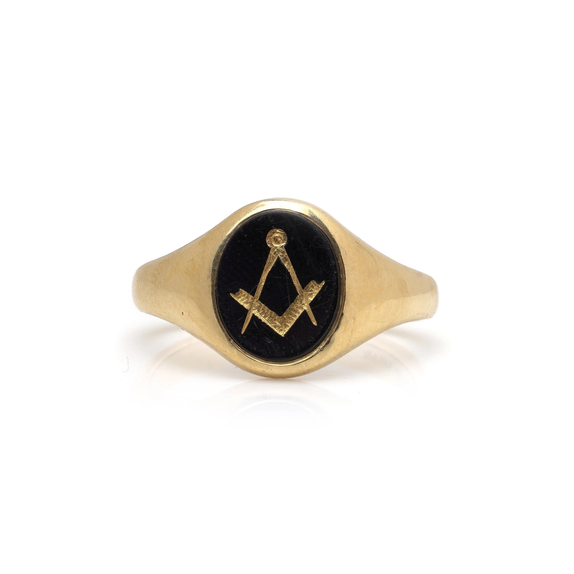 A yellow gold signet ring with an oval onyx masonic plaque