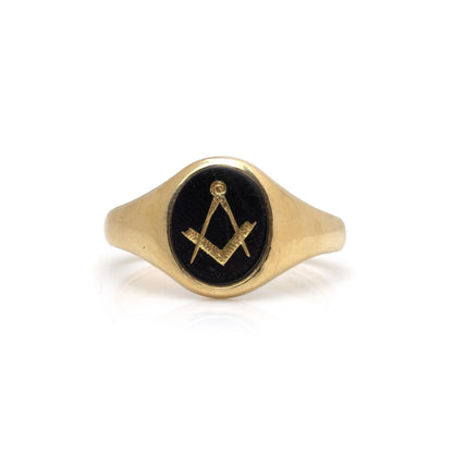 A yellow gold signet ring with an oval onyx masonic plaque