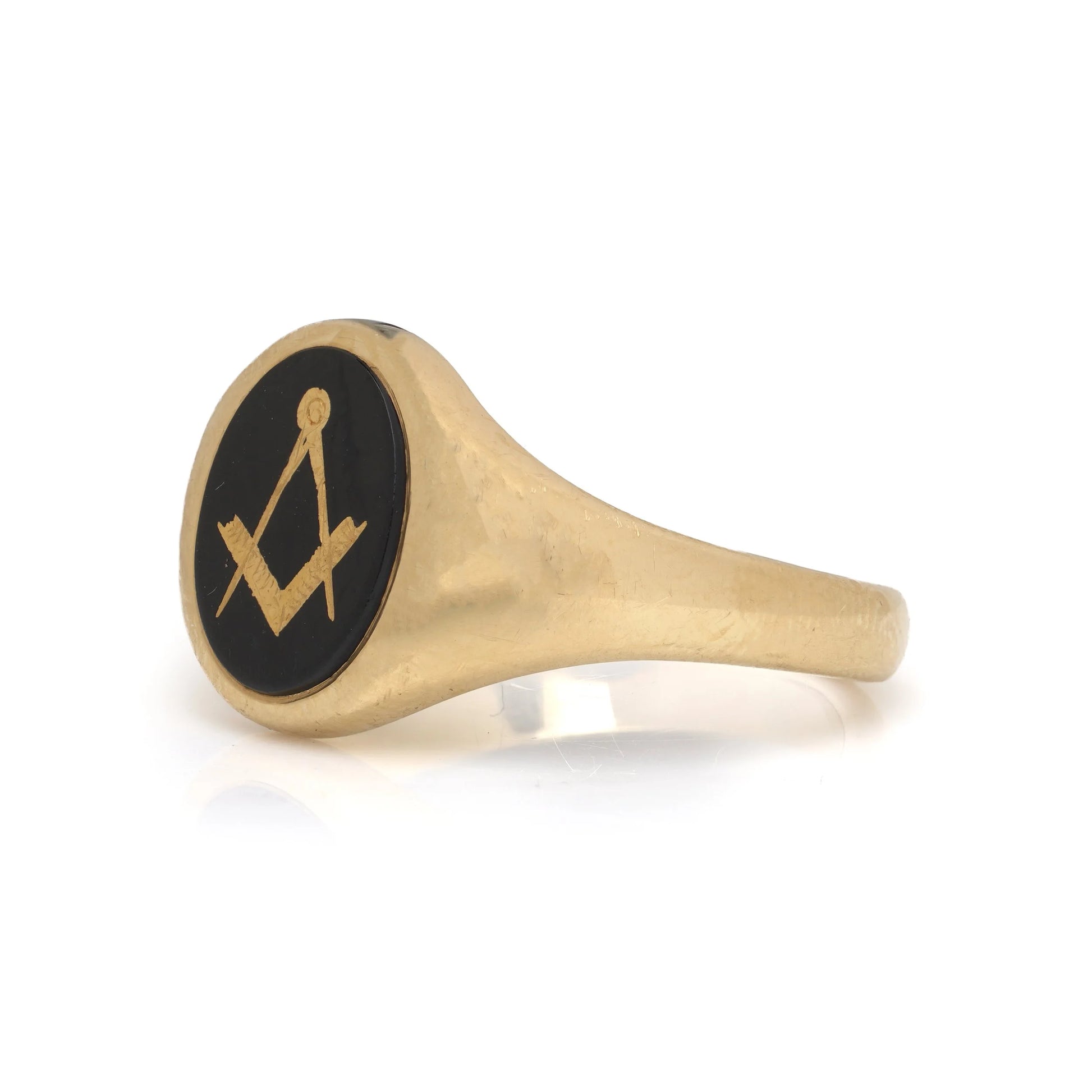 A yellow gold signet ring with an oval onyx masonic plaque