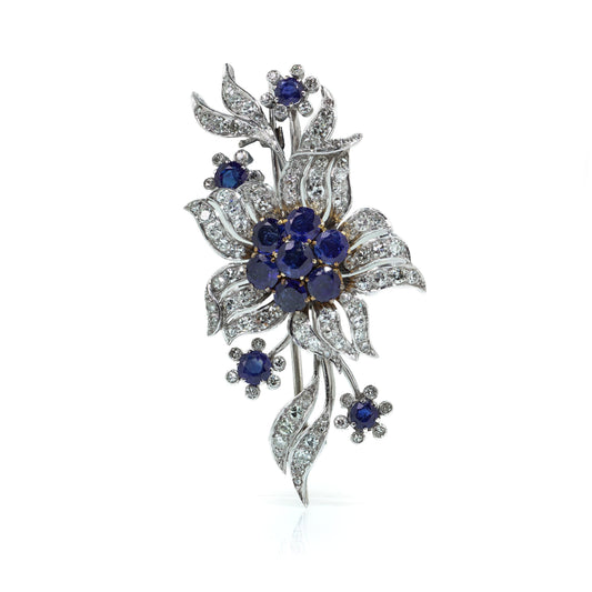 A flower spray brooch set with sapphires and diamonds, set in palladium