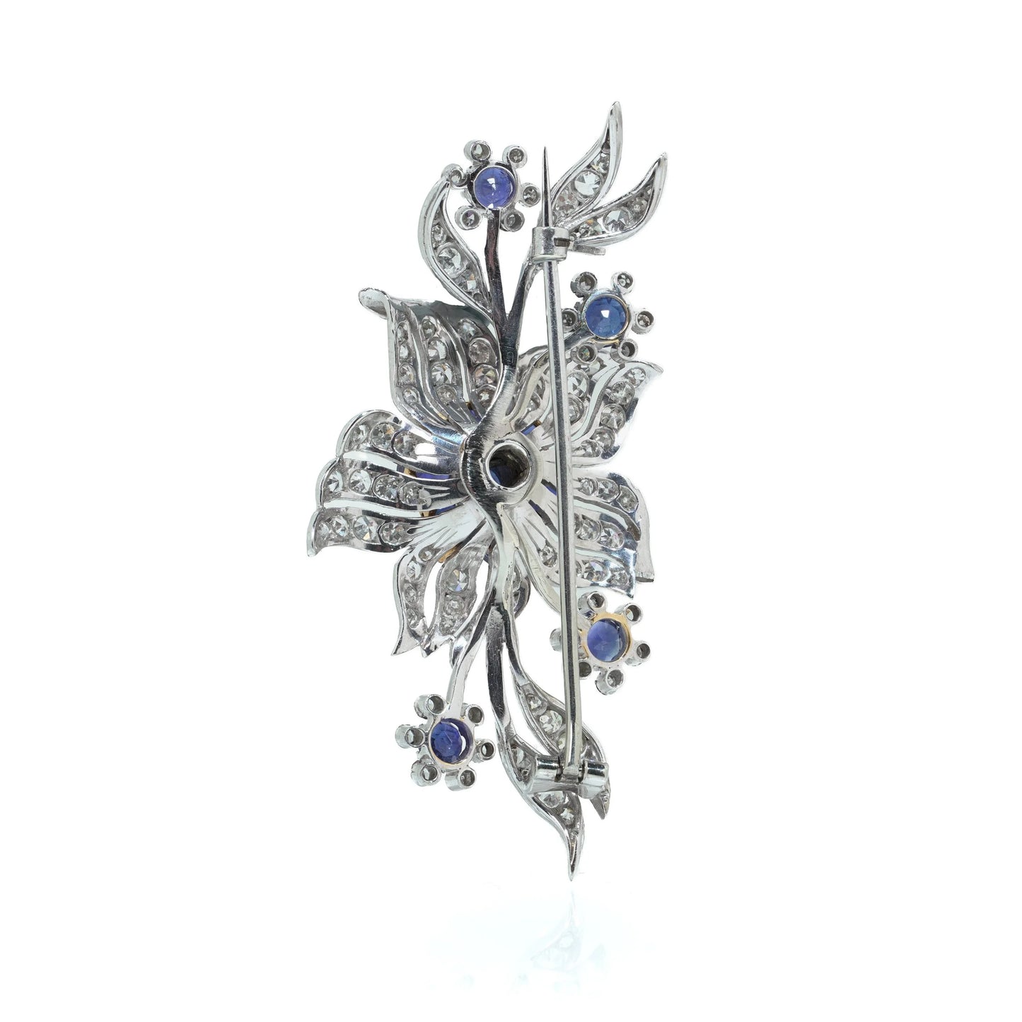 A flower spray brooch set with sapphires and diamonds, set in palladium