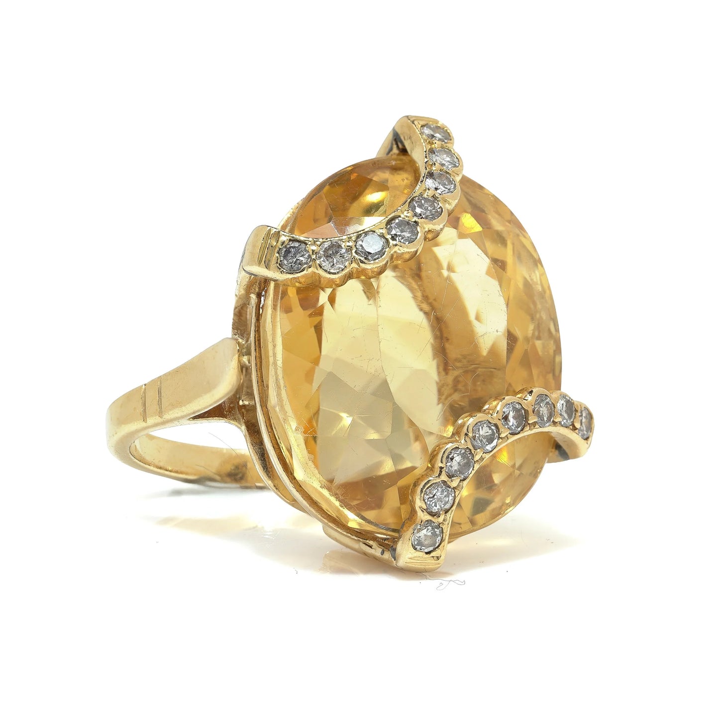 An oval citrine and diamond cocktail ring in yellow gold