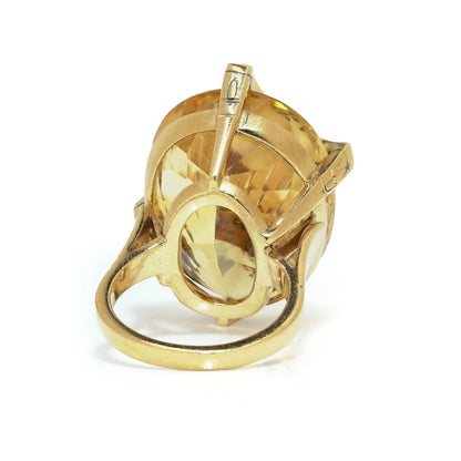 An oval citrine and diamond cocktail ring in yellow gold