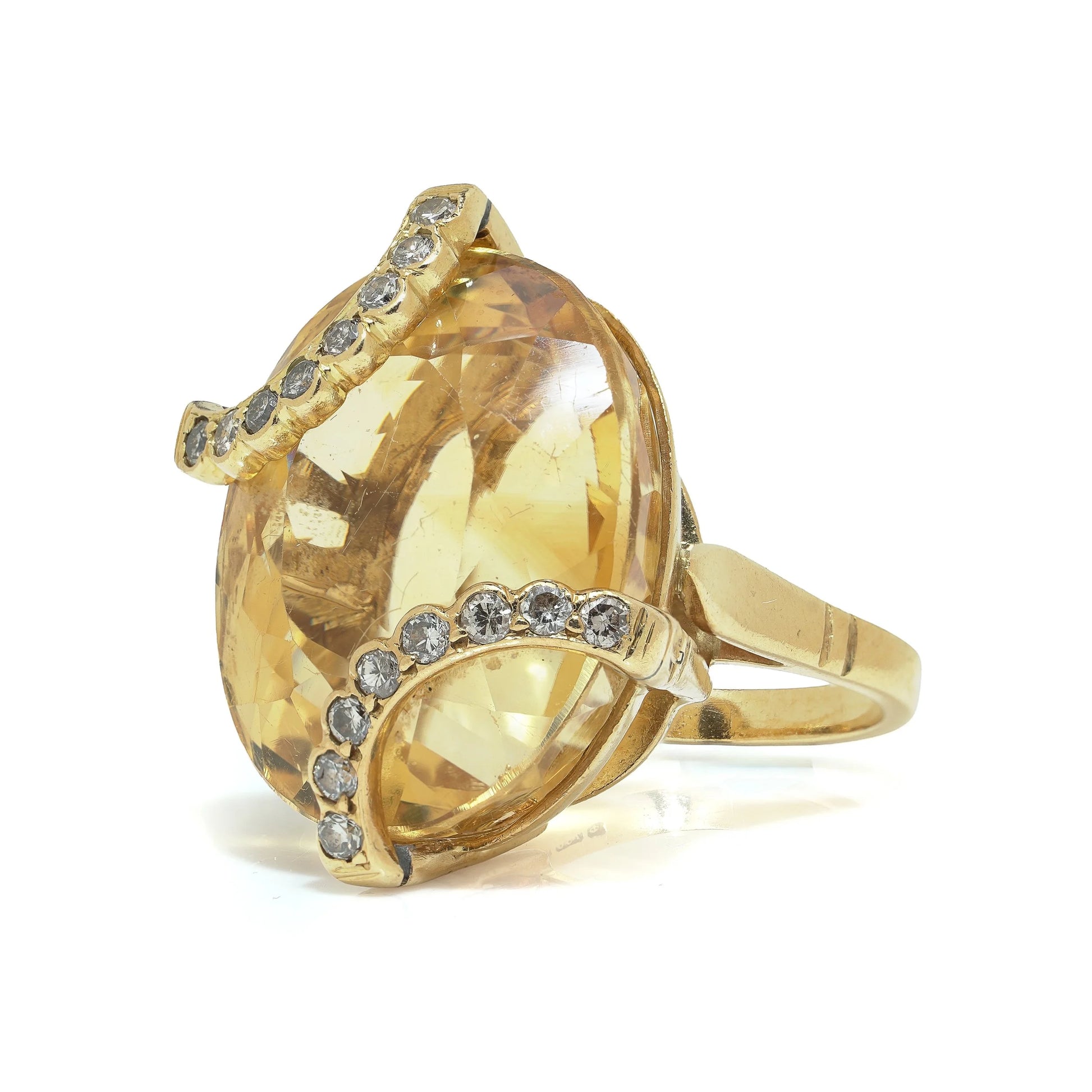 An oval citrine and diamond cocktail ring in yellow gold