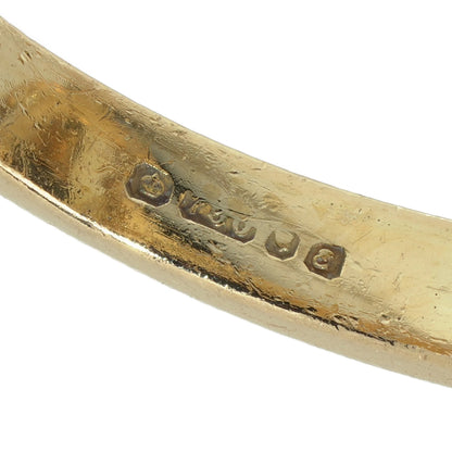 Close-up of an 18 carat gold hallmark inside a yellow gold ring shank
