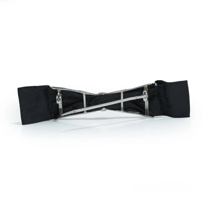 A floral design diamond and platinum bow brooch with a black ribbon