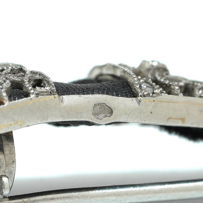 Close-up of a stamp on a platinum brooch