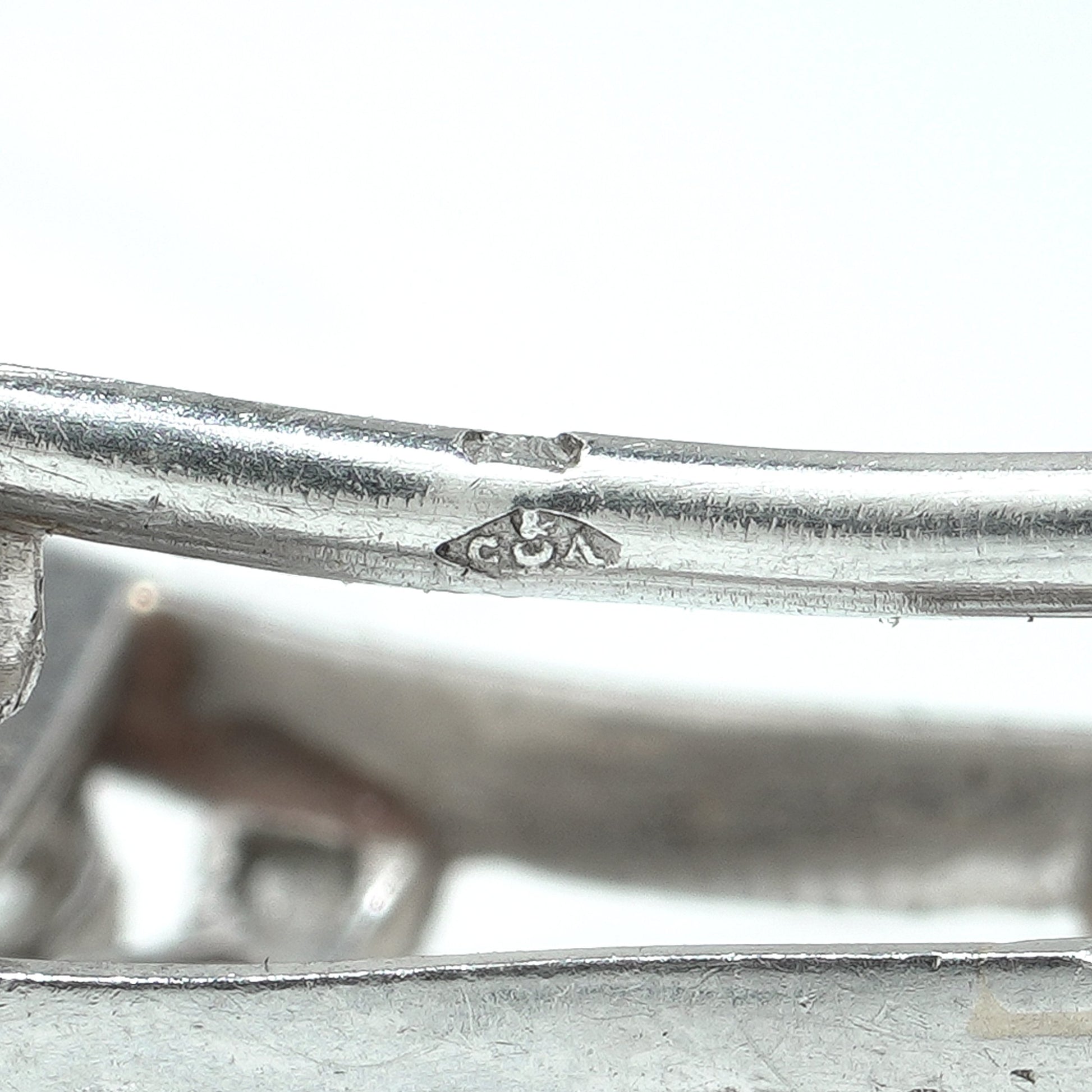 Close-up of a Cartier stamp on a platinum brooch