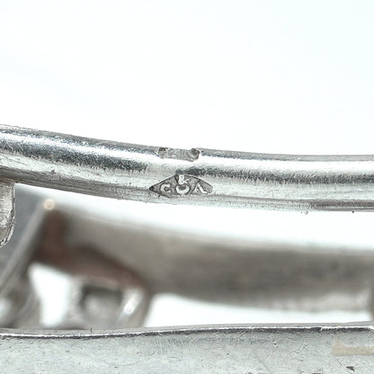 Close-up of a Cartier stamp on a platinum brooch