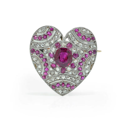 A heart shaped brooch set with rubies and diamonds, in platinum and gold