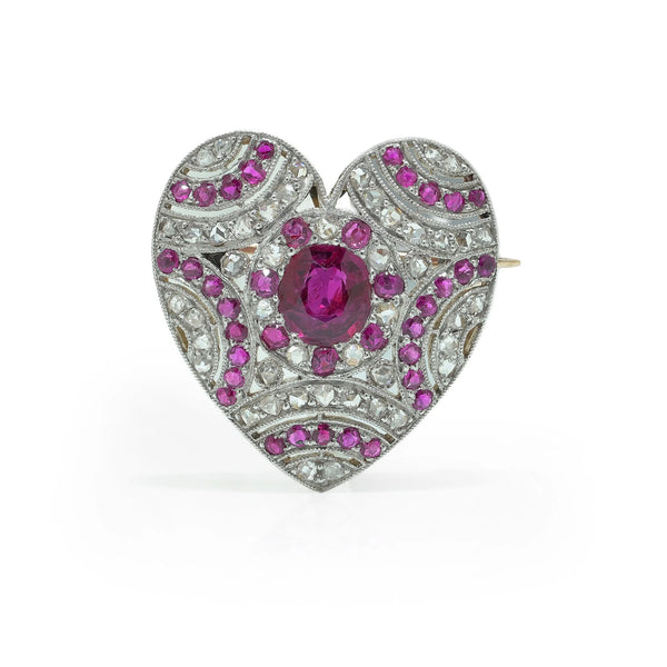 A heart shaped brooch set with rubies and diamonds, in platinum and gold