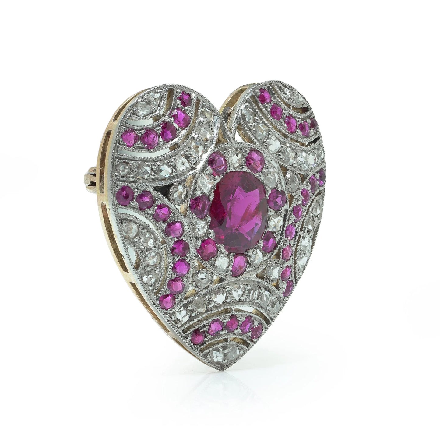 A heart shaped brooch set with rubies and diamonds, in platinum and gold