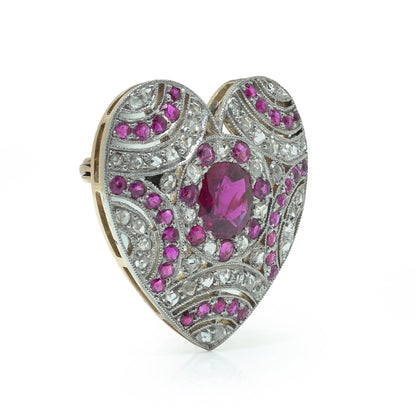 A heart shaped brooch set with rubies and diamonds, in platinum and gold