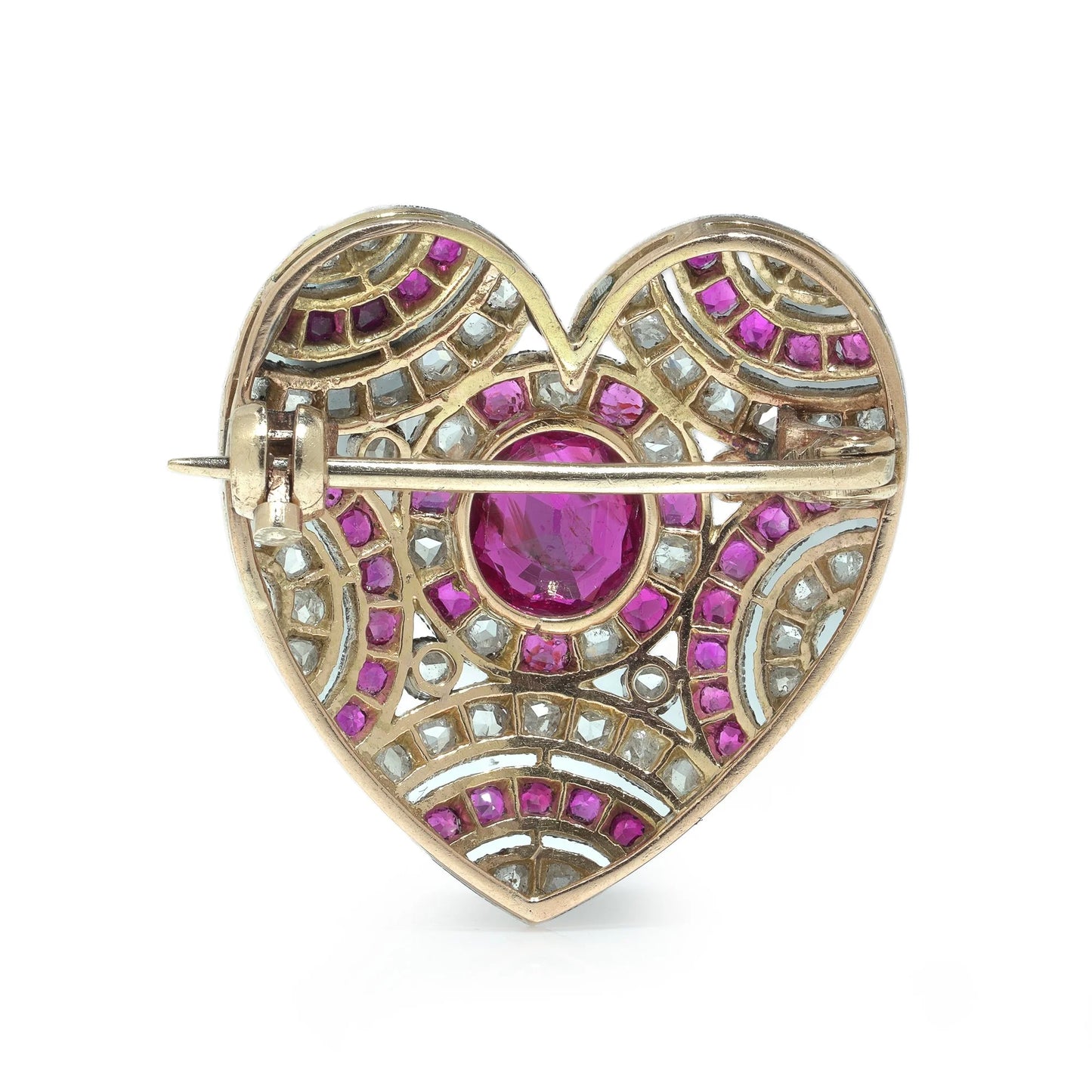 A heart shaped brooch set with rubies and diamonds, in platinum and gold