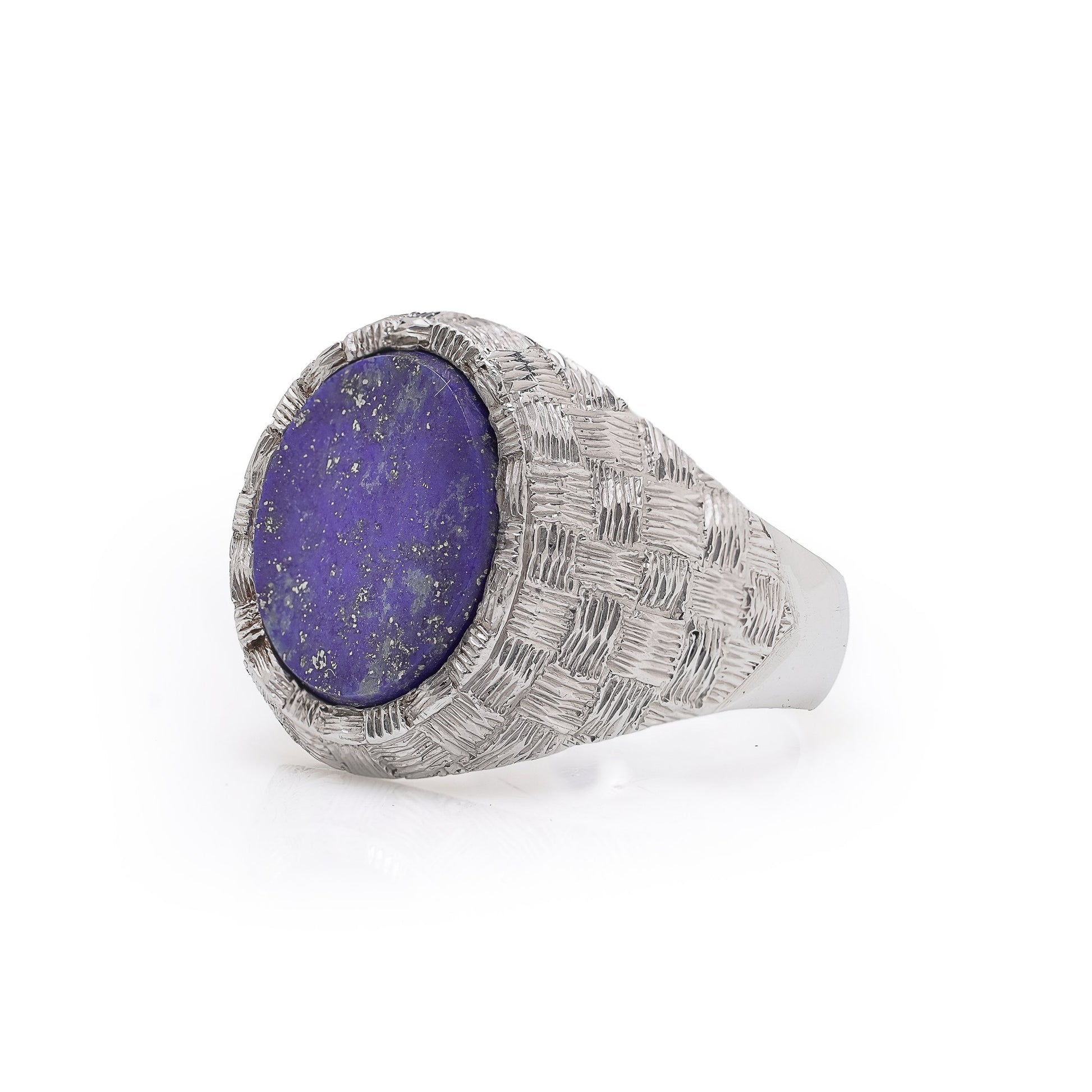 A white gold textured ring with an oval lapis lazuli