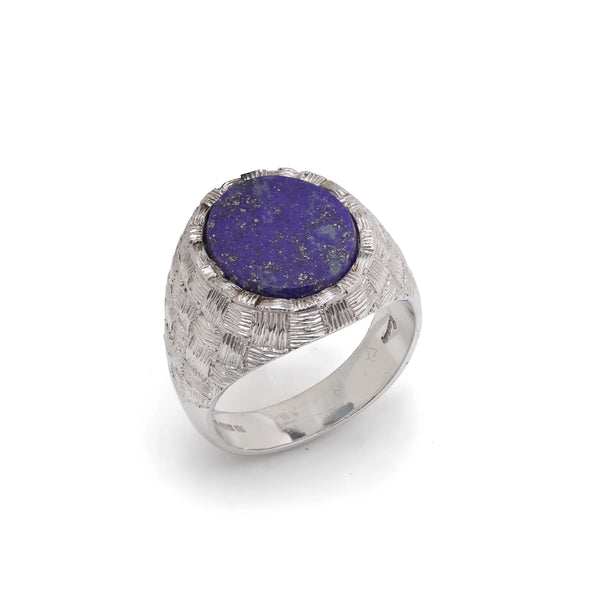 A white gold textured ring with an oval lapis lazuli