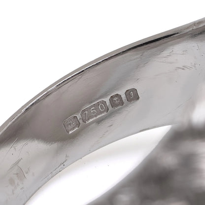 Close-up of an 18 carat white gold hallmark inside a ring shank